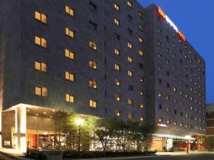 a large hotel building with lights on at ibis Ambassador Seoul Insadong in Seoul