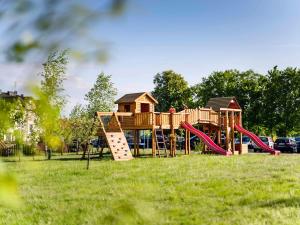 a playground in a park with a slide at Dosłońce Resort Wellness & Farm in Racławice