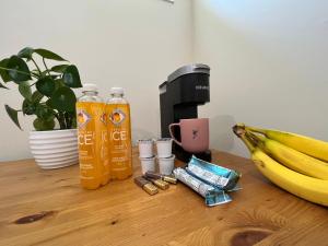 a table with a coffee maker and a bunch of bananas at Luxury Restful Sleepover Spot in Winnipeg