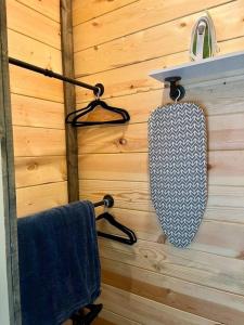 a bathroom with two towels and a mirror on a wall at #4 Kentucky Bourbon Trail Bourbon Barrel Cottages in Lawrenceburg