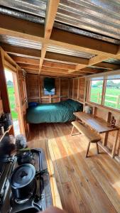 a room with a bed in a tiny house at Cosy Little Hut in Launceston