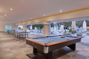 a billiard room with a pool table and chairs at DoubleTree by Hilton Bodrum Isil Club Ultra All-Inclusive Resort in Torba