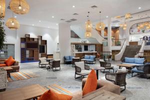 a lobby with couches and chairs and tables at DoubleTree by Hilton Bodrum Isil Club Ultra All-Inclusive Resort in Torba