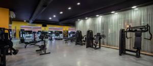 a gym with a row of treadmills and machines at DoubleTree by Hilton Bodrum Isil Club Ultra All-Inclusive Resort in Torba
