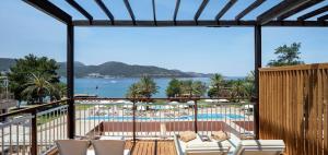 a view of the beach from the balcony of a resort at DoubleTree by Hilton Bodrum Isil Club Ultra All-Inclusive Resort in Torba