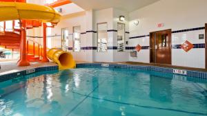 a swimming pool with a slide in a building at Best Western Plus Service Inn & Suites in Lethbridge