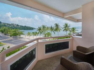 a balcony with chairs and a view of the ocean at HOMM Bliss Southbeach Patong in Patong Beach