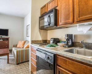 a kitchen with a sink and a microwave at MainStay Suites St Robert-Fort Leonard Wood in Saint Robert