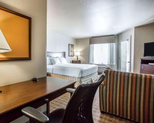 a hotel room with a bed and a desk at MainStay Suites St Robert-Fort Leonard Wood in Saint Robert
