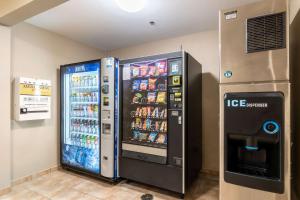 a refrigerator and a drink vending machine in a room at Sleep Inn & Suites Ronks in Ronks
