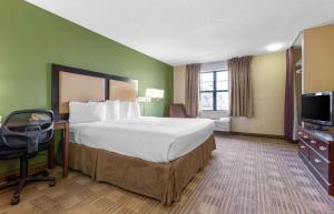 a hotel room with a bed and a television at Extended Stay America Suites - Phoenix - Peoria in Peoria