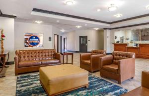 a waiting room with leather couches and a bar at Extended Stay America Suites - Houston - Kingwood in Kingwood