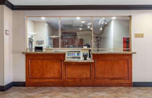 a bar in a restaurant with a large mirror at Extended Stay America Suites - Houston - Kingwood in Kingwood