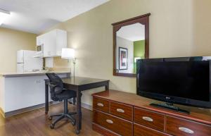 a hotel room with a desk and a television at Extended Stay America Suites - Tucson - Grant Road in Tucson