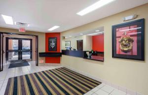a lobby with a waiting room with red walls at Extended Stay America Select Suites - Springfield - South in Springfield