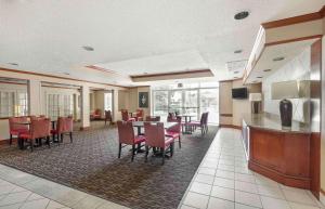 a dining room with tables and chairs in a restaurant at Extended Stay America Suites - Dallas - Frankford Road in Plano