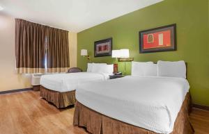 巴吞鲁日Extended Stay America Select Suites - Baton Rouge - Citiplace的绿墙旅馆客房的两张床