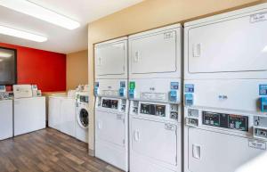 a laundry room with white washer and dryer machines at Extended Stay America Suites - Denver - Tech Center South - Inverness in Centennial