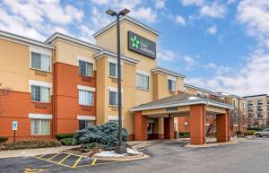 a hotel with a sign on top of a building at Extended Stay America Suites - Chicago - Schaumburg - Convention Center in Schaumburg