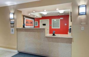 a waiting area in a hospital with a red wall at Extended Stay America Suites - Chicago - Schaumburg - Convention Center in Schaumburg