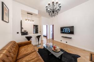 a living room with a couch and a table at Villa Montmartre 4P-Sacré Cœur in Paris