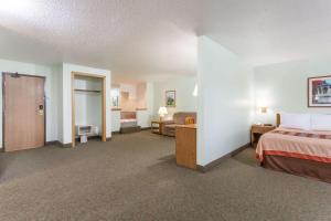 a hotel room with a bed and a bedroom with a bed sqor at Super 8 by Wyndham Gallipolis Pt Pleasant Area in Gallipolis
