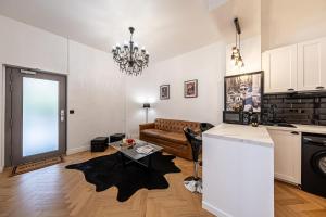 a living room with a couch and a table at Villa Montmartre 4P-Sacré Cœur in Paris +6 photos