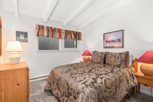 a bedroom with a bed and a desk and a window at Aspen West End Home in Aspen