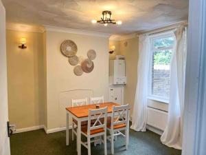 a kitchen with a table and chairs and a window at Canterbury King bed house with Free Parking & Garden in Canterbury