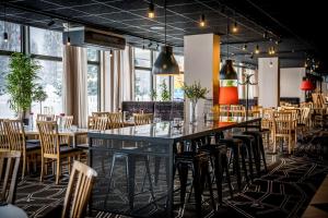 a dining room with a long table and chairs at Scandic Umeå Syd in Umeå