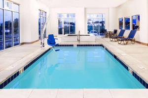 a swimming pool with blue water in a building at Microtel Inn & Suites by Wyndham Vernal/Naples in Vernal