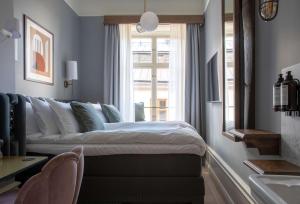 Rúm í herbergi á Hotel Frantz, WorldHotels Crafted