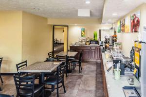 a restaurant with tables and chairs and a kitchen at Quality Inn Decatur near US-224 in Decatur