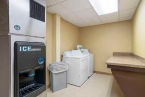 a utility room with a washer and dryer in a building at Comfort Suites At WestGate Mall in Spartanburg
