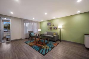 a living room with a couch and a table at WoodSpring Suites Wixom - Novi in Wixom
