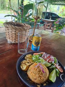 einen Tisch mit einem Teller Essen und einem Getränk in der Unterkunft Garza del Sol Glamping Río Celeste Buganvilia in San Rafael