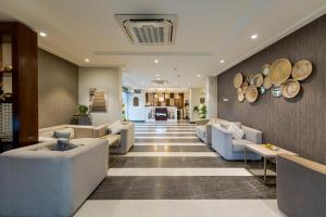 a lobby with couches and hats on the wall at Staytion First - Al Zahra in Jeddah