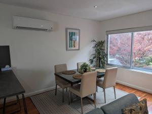 a dining room with a table and chairs at Spacious 2 bedroom apartment @Kingston Foreshore in Kingston 