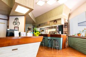 a restaurant with a counter and stools in a room at Hotel Diamond in Rimini