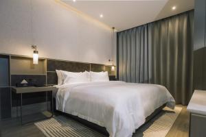 Voodi või voodid majutusasutuse Orienwit Hotel-Free Shuttle Bus fir Canton Fair toas