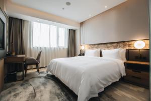 Voodi või voodid majutusasutuse Orienwit Hotel-Free Shuttle Bus fir Canton Fair toas