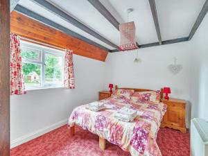 Tarrant Cottage -14557 في West Orchard: غرفة نوم بسرير ونافذة