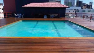 a swimming pool on the roof of a building at Hotel Victory Business Flat Beira Mar Tambaú in João Pessoa