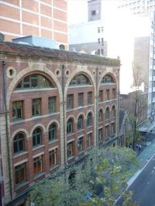 an old brick building with arches on a city street at PI702 - Ideally Located Sydney CBD in Sydney