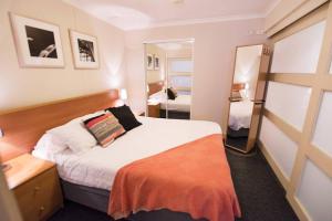 a hotel room with a bed and a mirror at PI702 - Ideally Located Sydney CBD in Sydney