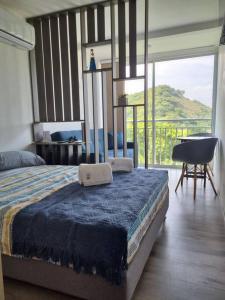 a bedroom with a bed and a table and a balcony at Apartamento Nuevo en Santa Marta Rodadero in Gaira