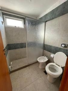 a bathroom with a toilet and a shower stall at DUPLEX BV in Bell Ville
