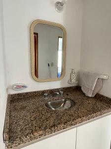 bagno con lavandino e specchio di DUPLEX BV a Bell Ville