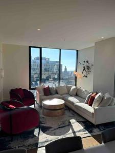 a living room with a couch and a large window at Lux 2BR 2BR BackBay Boston Common T-station in Boston