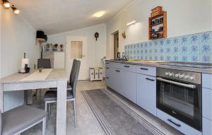 a kitchen with a counter and a table and a stove at Beautiful Home In Erfurt With Kitchen in Erfurt